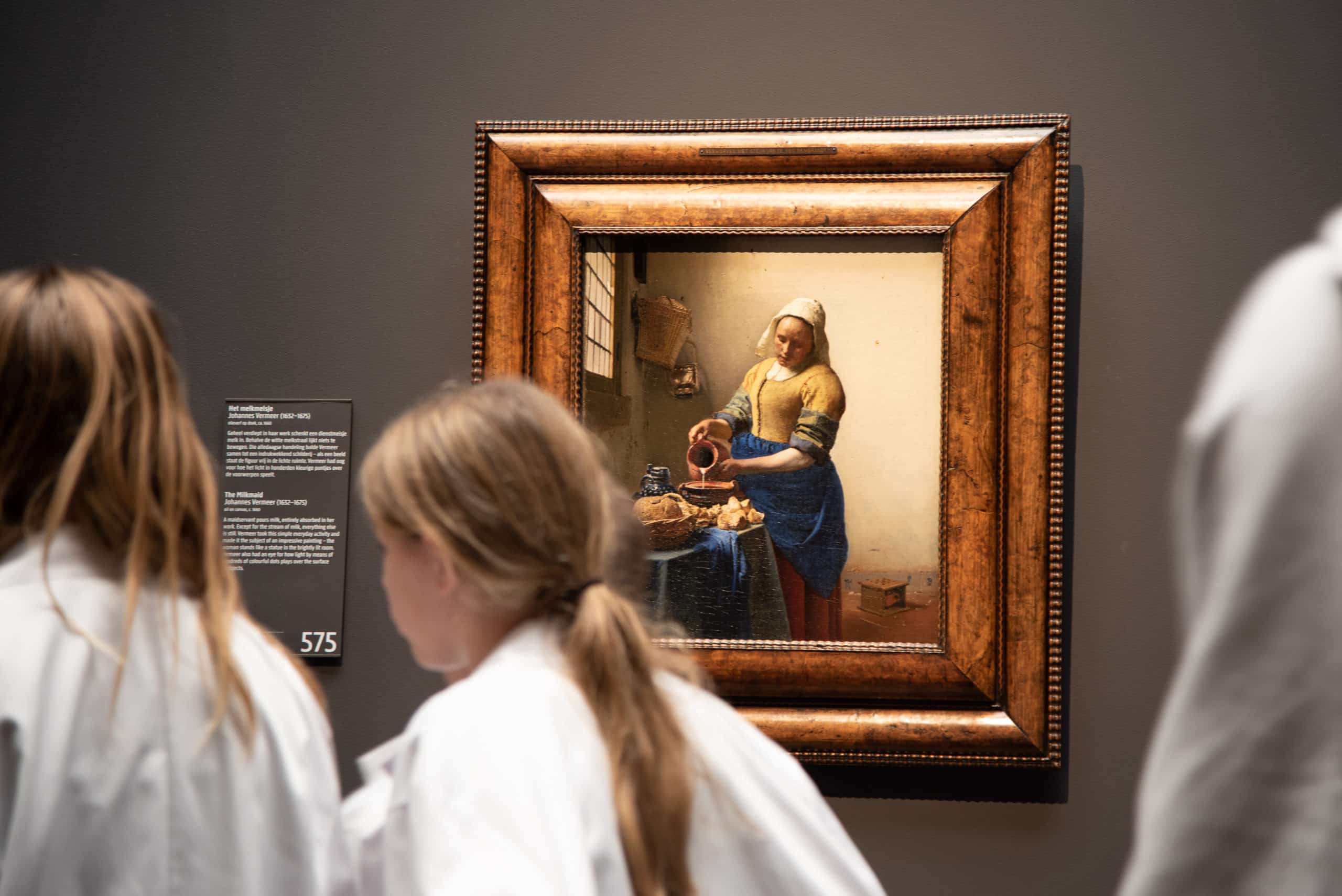 Amsterdam, Netherlands. December 2022. Visitors admire Vermeer's Milkmaid at the Rijksmuseum. High quality photo